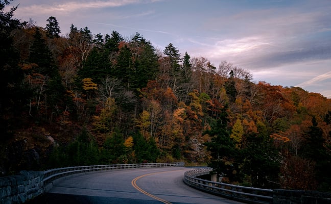 Winding Blue Ridge Parkway road through autumn mountain foliage