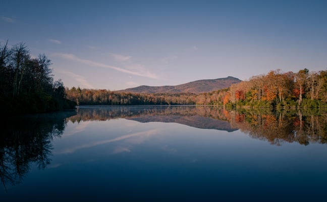 Still mountain lake with autumn trees reflected in calm water, Blue Ridge foothills